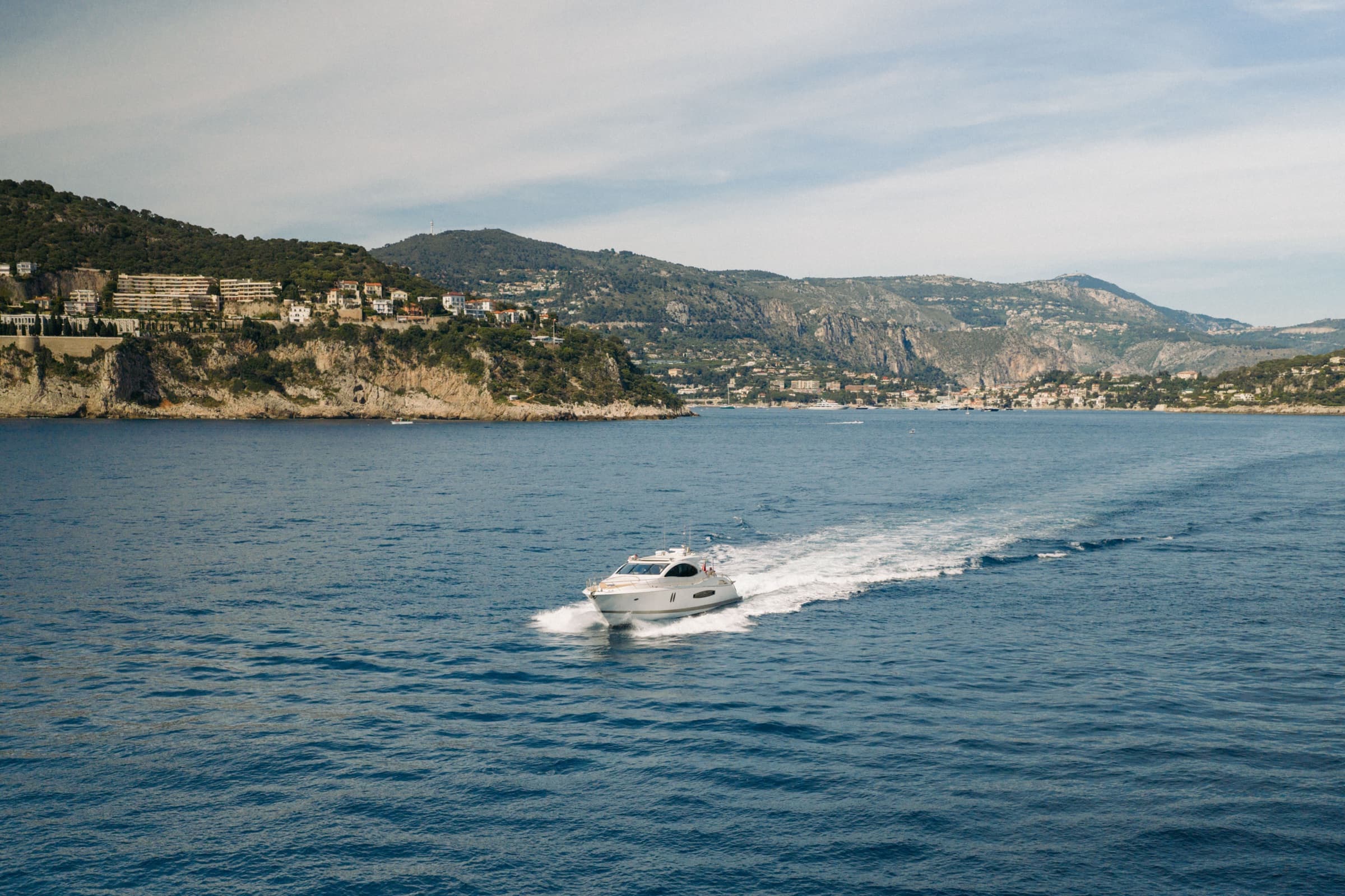 Aerial of Sans Regret cruising along the coast